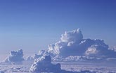 Towering Cumulus clouds in misty blue aerial view