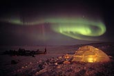 Aurora over a lit up Inuit igloo in the Northern Canada arctic