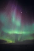 Folds in curtains of red and green Aurora Borealis (northern lights)