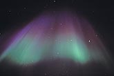 A corona of purple and green northern lights (Aurora Borealis)