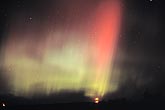 Brilliant red and green rays of northern lights (Aurora Borealis) 