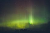 Intense green and red curtains of Aurora Borealis
