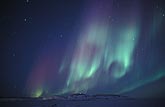 Red, purple and green northern lights over starlit arctic snow