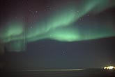 Bands of northern lights (Aurora Borealis) over arctic snow fields