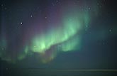 Green and purple curtains of northern lights (Aurora Borealis)