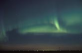 A brushy green curtain of northern lights in a prairie twilight