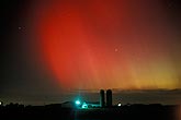 Blood in the skies: brilliant red northern lights wash over a farm