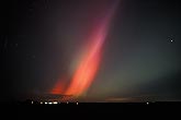 A red spear of Aurora Borealis looks like a brilliant flame