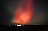 Flaming red northern lights (Aurora Borealis) in the night sky
