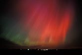 Avenging angel: red Aurora Borealis in the night sky