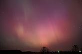 Glowing red and purple streaks of northern lights (Aurora Borealis)