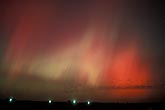 Phantoms of red and green Aurora Borealis in the night sky