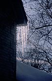 Glistening icicles hang from the eaves of a house