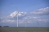Three wind turbines in a wind farm with Cumulus clouds