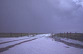 Deep hail in a heavy hailfall on a country road.