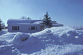 A house hidden behind heavy snowfall