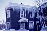 Large icicles hang from a poorly insulated house