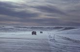 Vehicles on a highway in blowing snow
