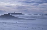 Blowing snow in blizzard over desolate landscape