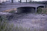 Dry riverbed under a bridge during drought