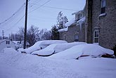 Parked cars buried in snow