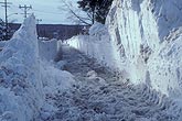 Deep opening cut for sidewalk through very high snowbanks
