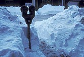 Parking meter in snow after a winter snow storm dumps its load