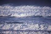 Crashing surf froths as wild waves roll shoreward