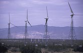 A windmill farm in the hot California desert with wind turbines