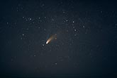 Comet Hale-Bopp streaks through a night sky filled with stars
