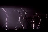 Lightning bolts strike along a power corridor