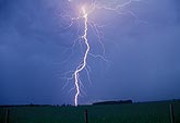 A surprise single lightning bolt strikes at dusk