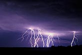 Multiple cloud-to-ground lightning bolts cast eerie light 