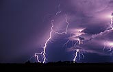 Jagged cloud-to-ground lightning bolts with glowing clouds