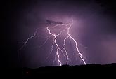 Detailed cloud-to-ground lightning with fine colored filaments