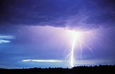 A highly electric lightning strike electrifying a twilight sky