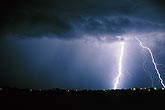 A town is struck by lightning as a brilliant highly electric bolt flashes