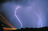 Multiple close cloud-to-ground lightning strikes as traffic tears 