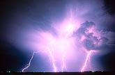 An explosion of power bolts of lightning electrifies the night sky