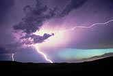 Brilliant superbolt lightning in a turquoise and purple sunset sky