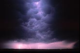 Intracloud lightning flashes glow through churning Mammatus