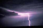 A single vivid cloud-to-ground lightning bolt
