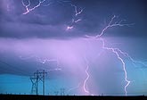 Electricity, wild and tame, with lightning over transmission towers