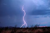 A single forked lightning bolt making strides across the desert 