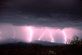 Highly electric multiple lightning bolts cast a pink glow