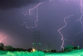 A tracery of lightning dwarfs a power corridor
