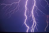 Searing lightning in a close-up of bolts with fine filaments