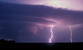 Lightning strikes light up a rotating wall cloud
