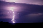 A single forked lightning bolt (thunderbolt) pierces a cloud 