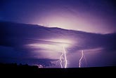 Two lightning bolts illuminate a storm